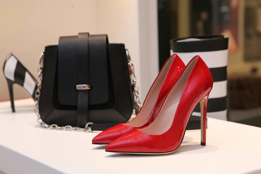 Red-High-Heel-Power-Shoe-Capsule-Wardrobe A single, sharp red high-heeled pump, embodying the 'power shoe' concept within a smart casual capsule wardrobe.