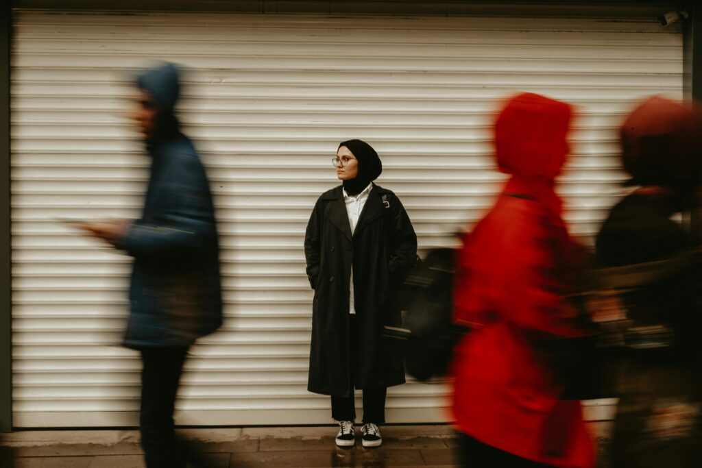 The Fear of Being Seen: A Strategic Guide for New Beginnings 2 A motion blur photo of a street scene with a woman's stylish handbag in sharp focus, illustrating the power of a single focus point to overcome the fear of being seen.