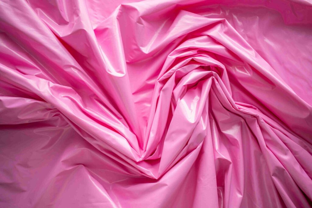 Synthetic fabric A pink, plastic kind of synthetic fabric.