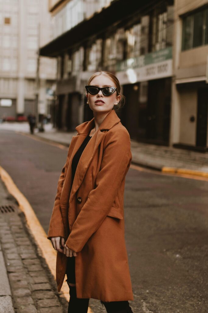 Classic-Trench-Coat-Structural-Capsule-Wardrobe A classic, sharply tailored trench coat, symbolizing instant authority and structure within a smart casual capsule wardrobe.