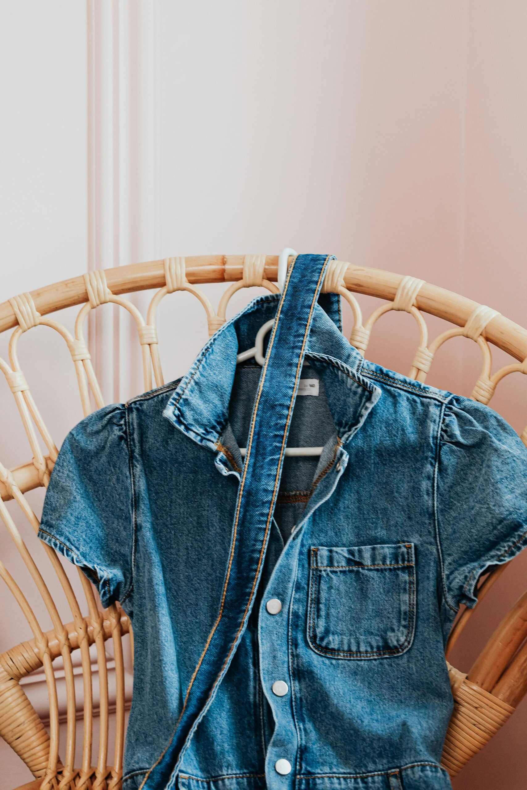 The Fear of Being Seen: A Strategic Guide for New Beginnings 4 A flat lay showing a classic pair of black trousers—an anchor piece—next to a bold, colourful blouse, representing a balanced approach to evolving personal style.