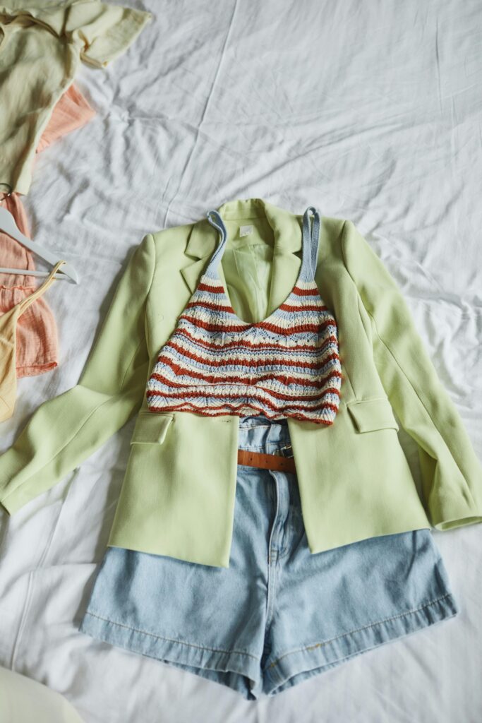 The Ghost in Your Closet: A Strategic Guide to Dressing for New Beginnings 2 A flat lay of a blazer, a sweater, and a watch, symbolizing a simple outfit formula for strategic dressing.