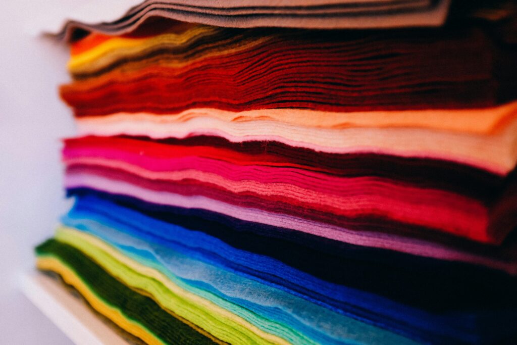 More Than a Mood: The Real Science of Dopamine Dressing 2 A neat array of colorful fabric swatches, showcasing a spectrum from warm to cool hues for dopamine dressing.