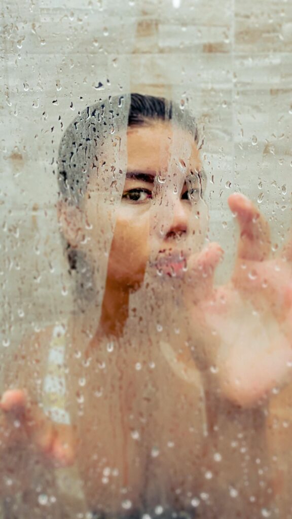 The Mirror Slump: How to Change What You See in Your Reflection 2  A close-up of a hand clearing a steamed-up mirror, a metaphor for the process of changing your reflection.