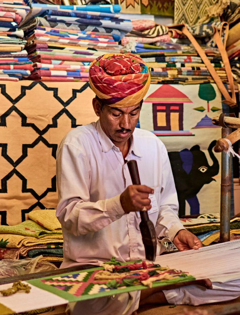 The skilled hands of an Indian artisan working on a traditional textile, representing the core reason why Indian fashion needs a global identity.