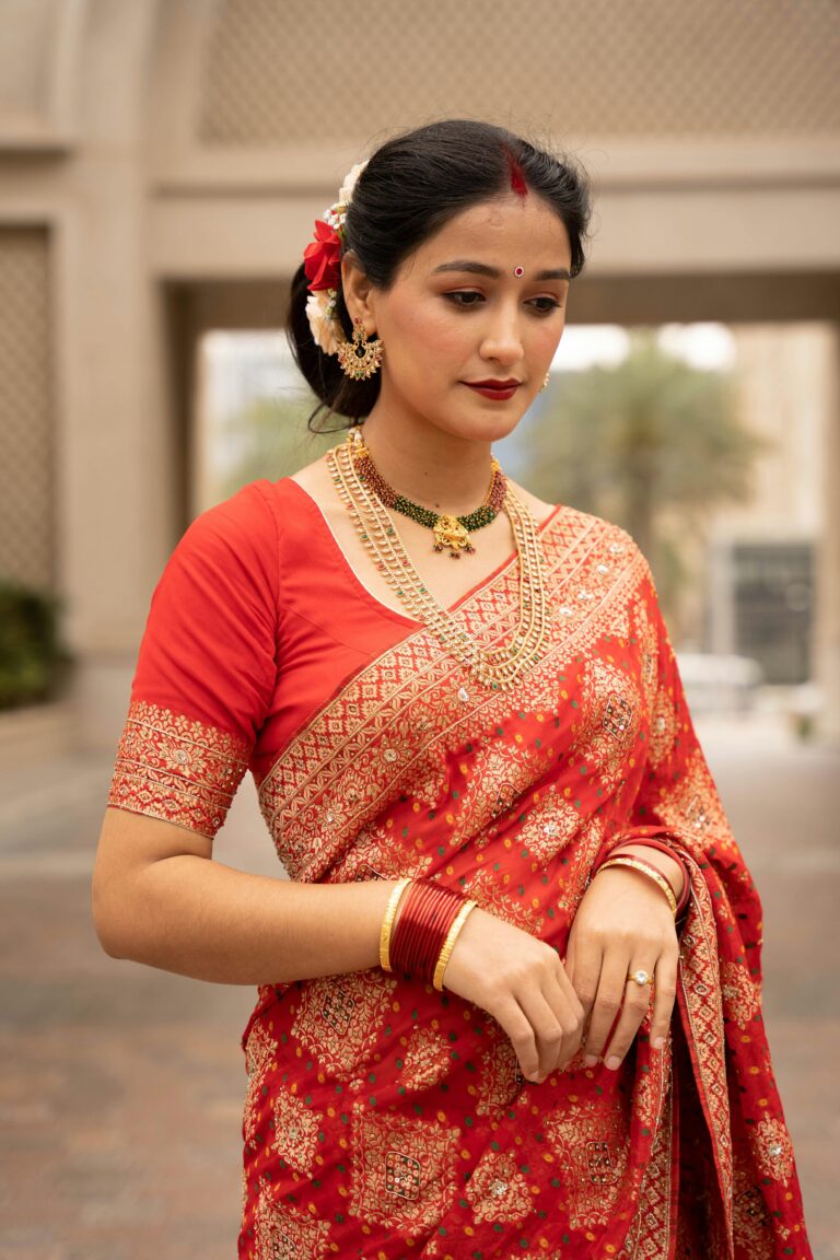 A chic, modern woman wearing an elegant saree, demonstrating its timeless style.