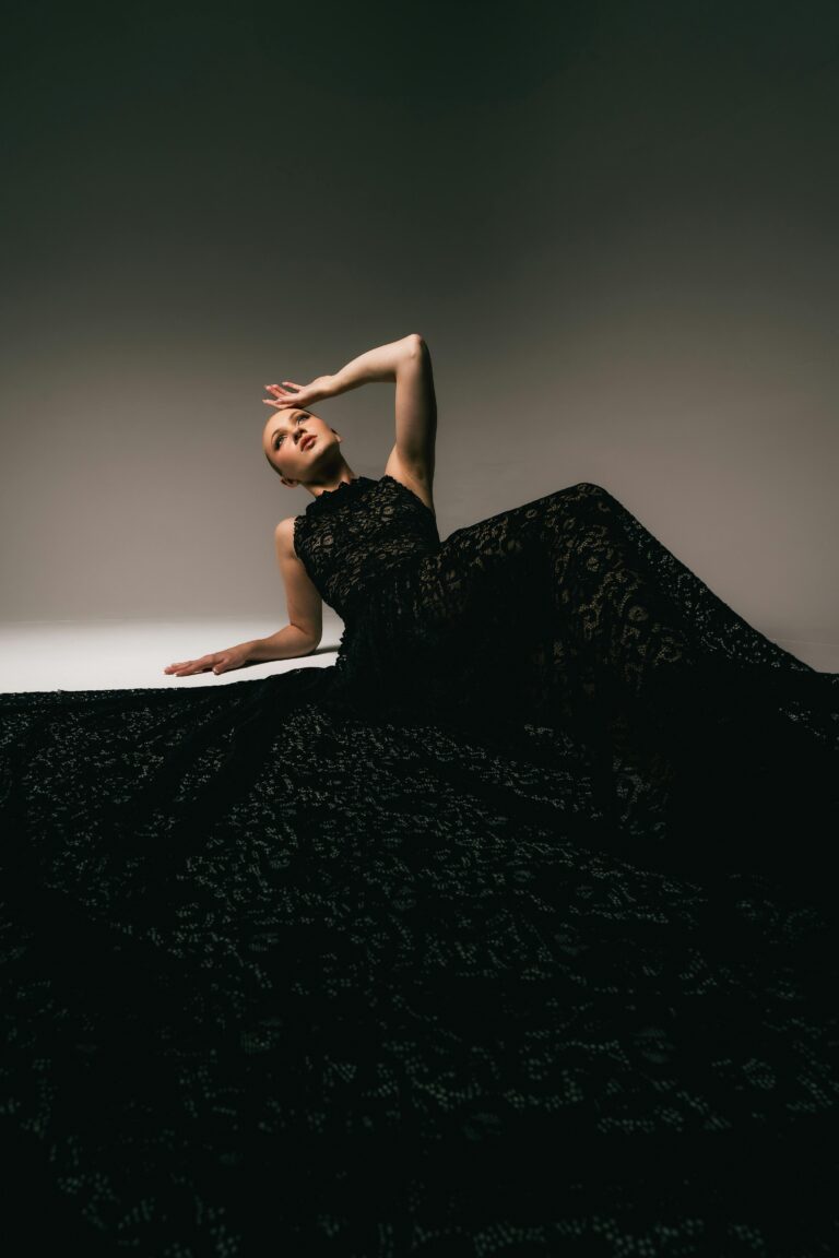 A detailed macro shot showing a women in black long dress. A editorial shot, showing the power of black.
