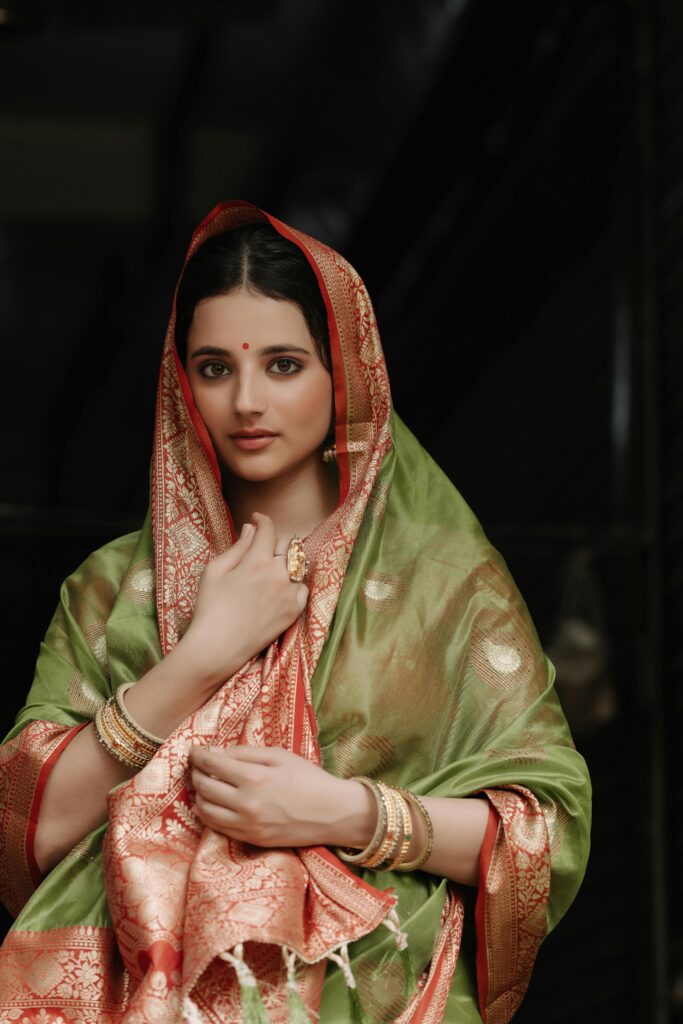 The Modern Woman’s Festive Playbook: Three Ways to Channel Intelligent Glamour 2 A close-up on the fluid, elegant drape of a soft silk saree, showcasing timeless festive dressing.