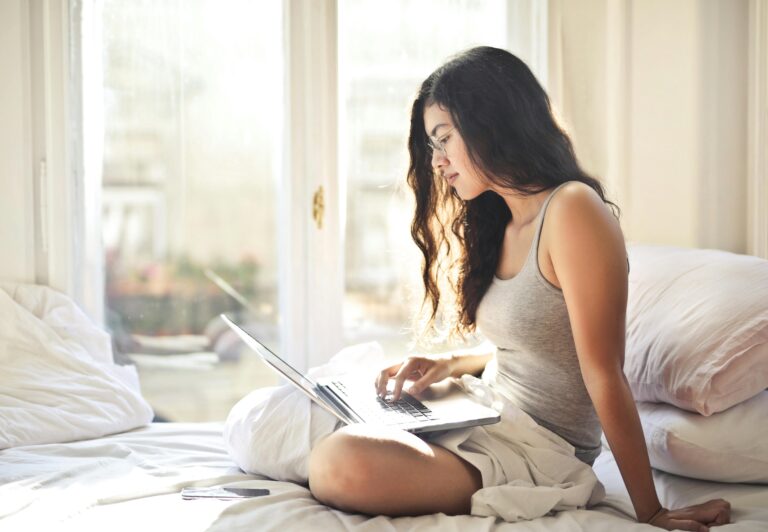A photo showing a woman in soft loungewear, showing work from home, and the reason of enclothed cognition.