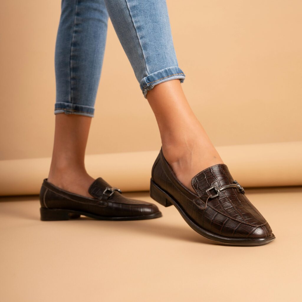 A classic leather loafer styled as an essential piece in a curated shoe wardrobe.